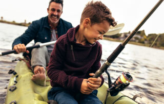 Father and son in boat fishing